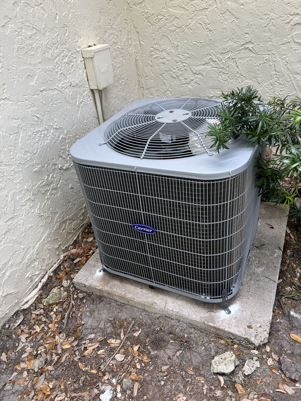 New residential condenser unit on a concrete pad